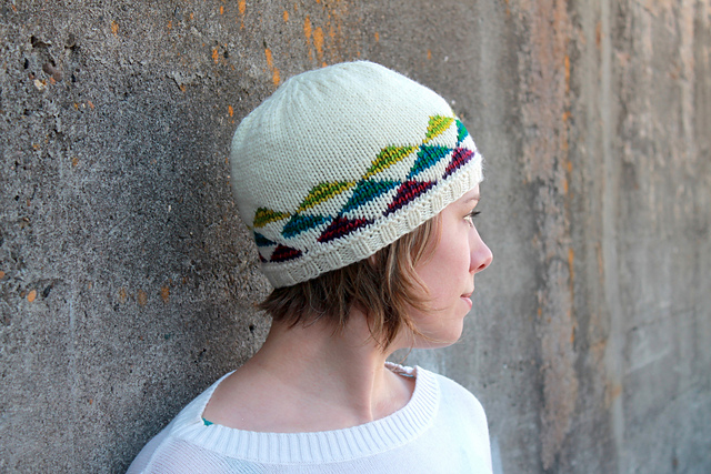 woman wearing knit hat with colorful triangles on it