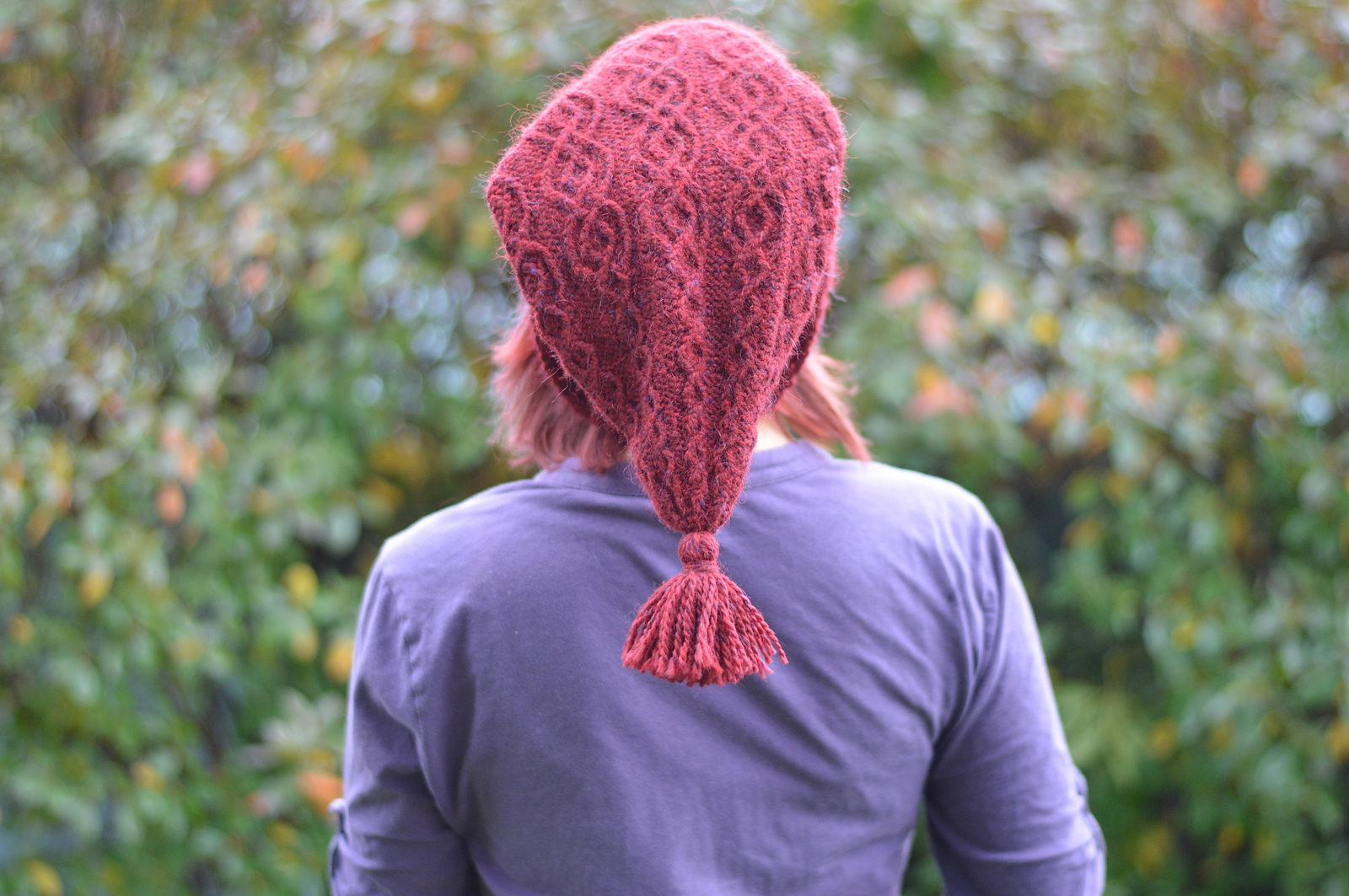 from behind woman in red hat looking up
