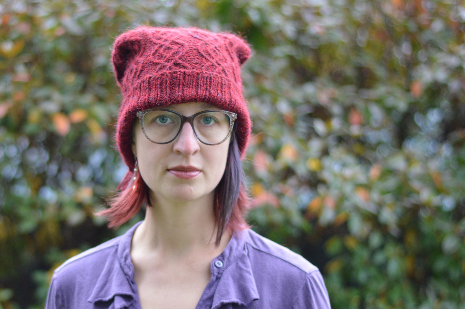 woman in red hat staring straight at camera