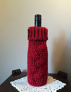 Download Ravelry: Cabled Sweater Wine Cozy Gift Bags pattern by Jennifer Ozses